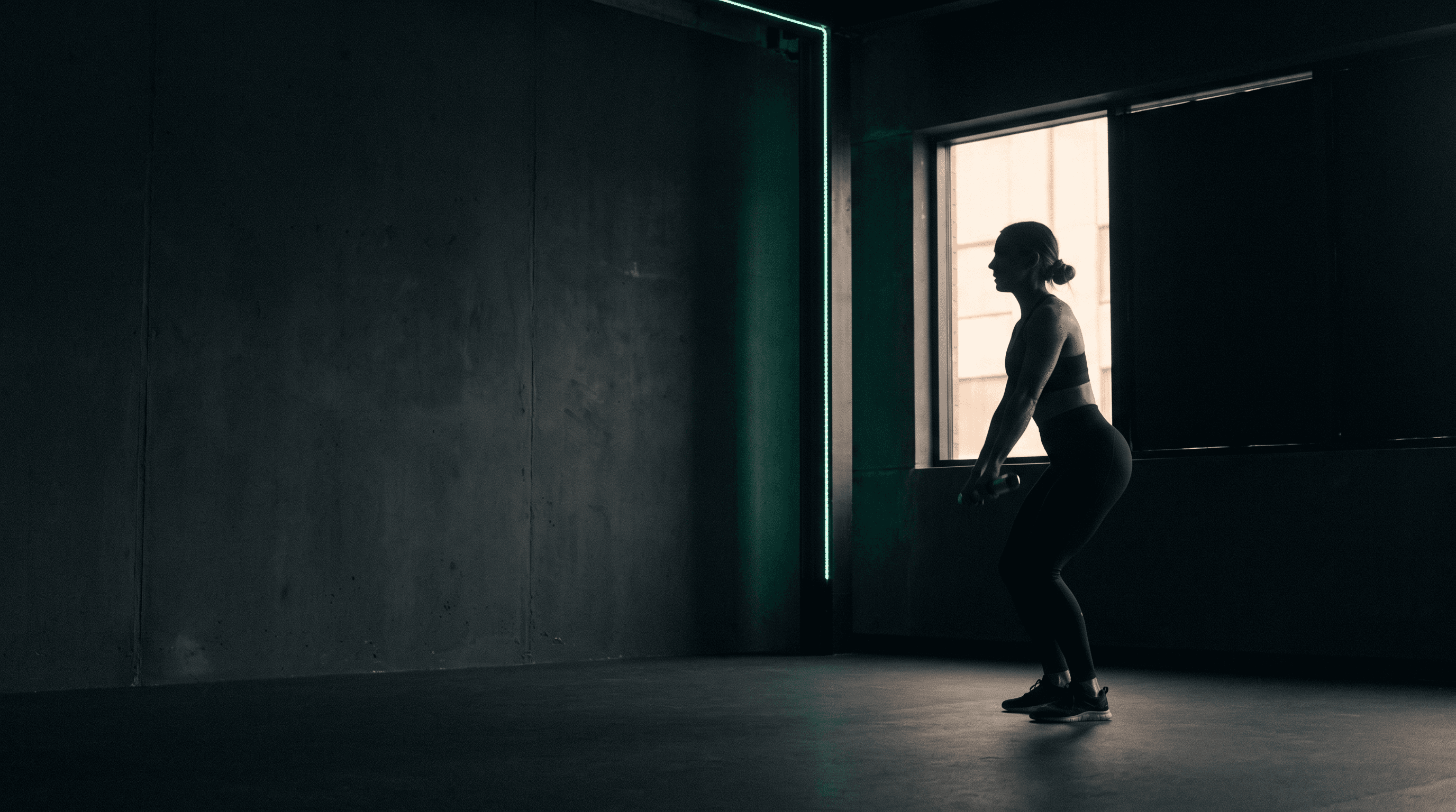 Athlete training in a minimal, low-lit studio